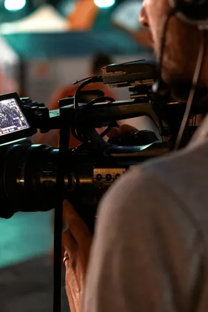 professional-cameraman-recording-poeple-watching-football-public-place-night.jpg