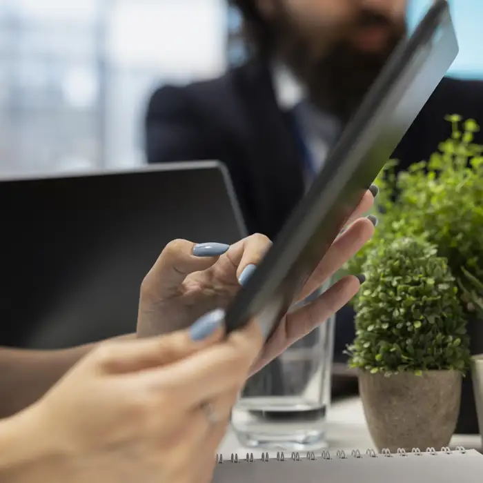 woman-reading-diagrams-tablet-device-helped-by-specialist.jpg