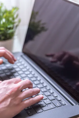 woman-sitting-chair-using-laptop-her-lap.jpg