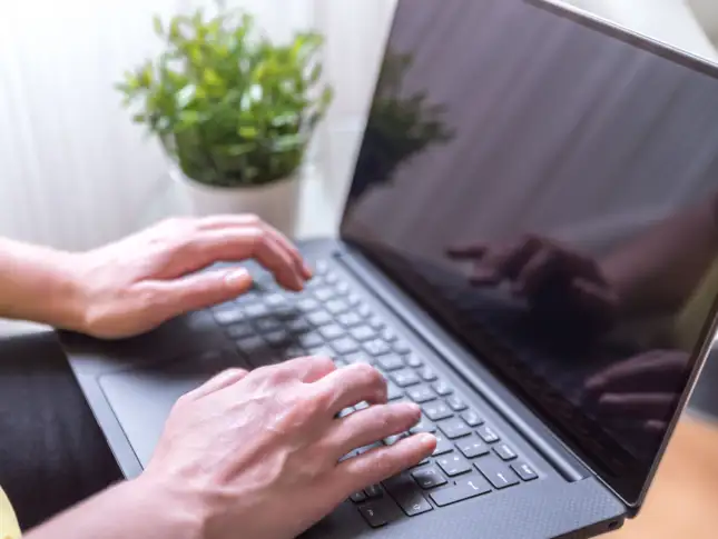 woman-sitting-chair-using-laptop-her-lap.jpg